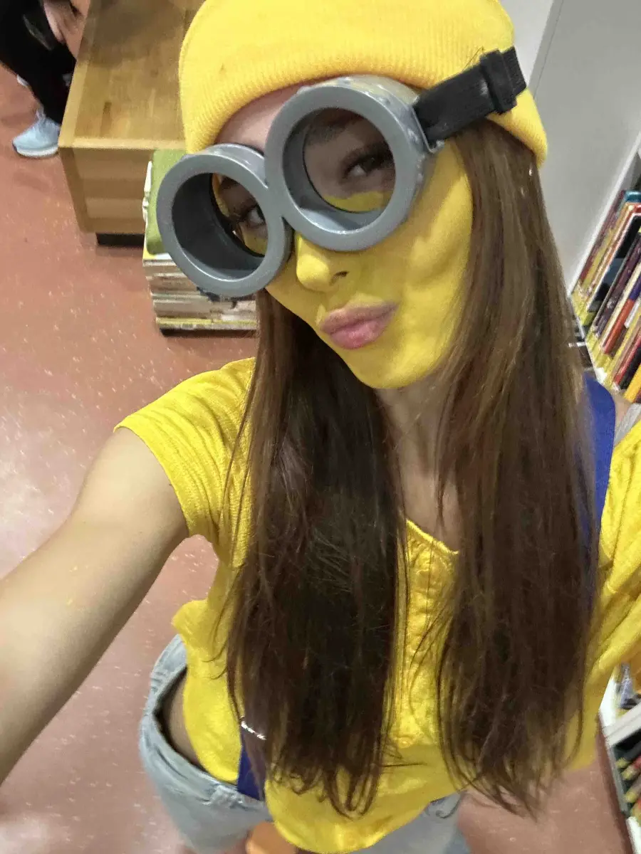 Diana in a Minion costume: yellow face paint, goggles and beanie