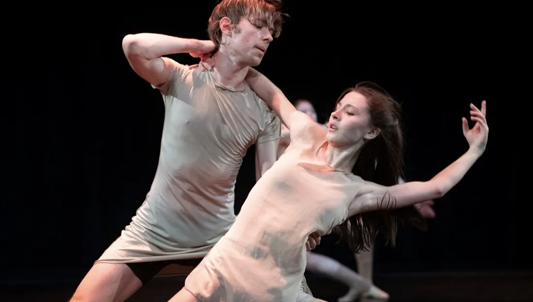 Diana on stage in a duet, arching back with one arm extended